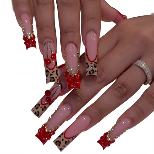 Cherry Bow Leopard press-on nails on hand