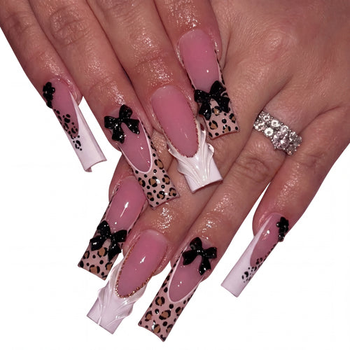 Coquette Leopard press-on nails on hand