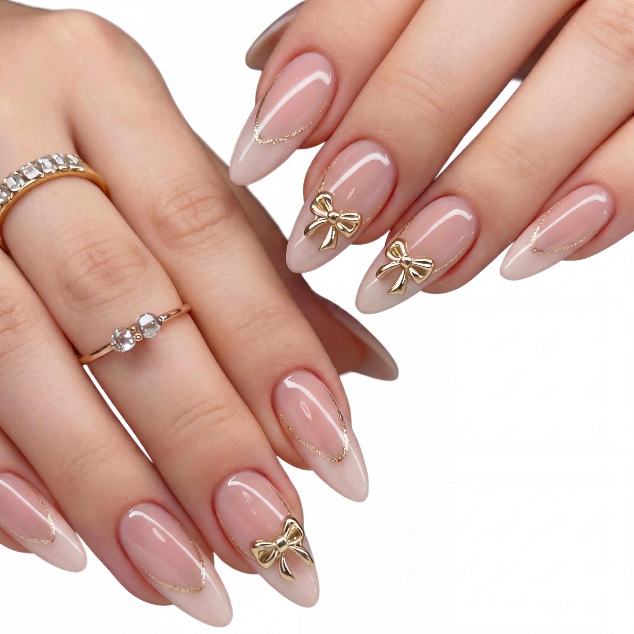 Golden Bow Nude press-on nails on hand