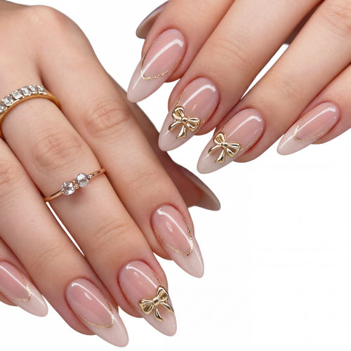 Golden Bow Nude press-on nails on hand