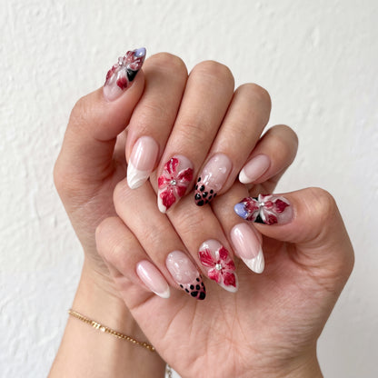 Crimson Lily press-on nails on hand